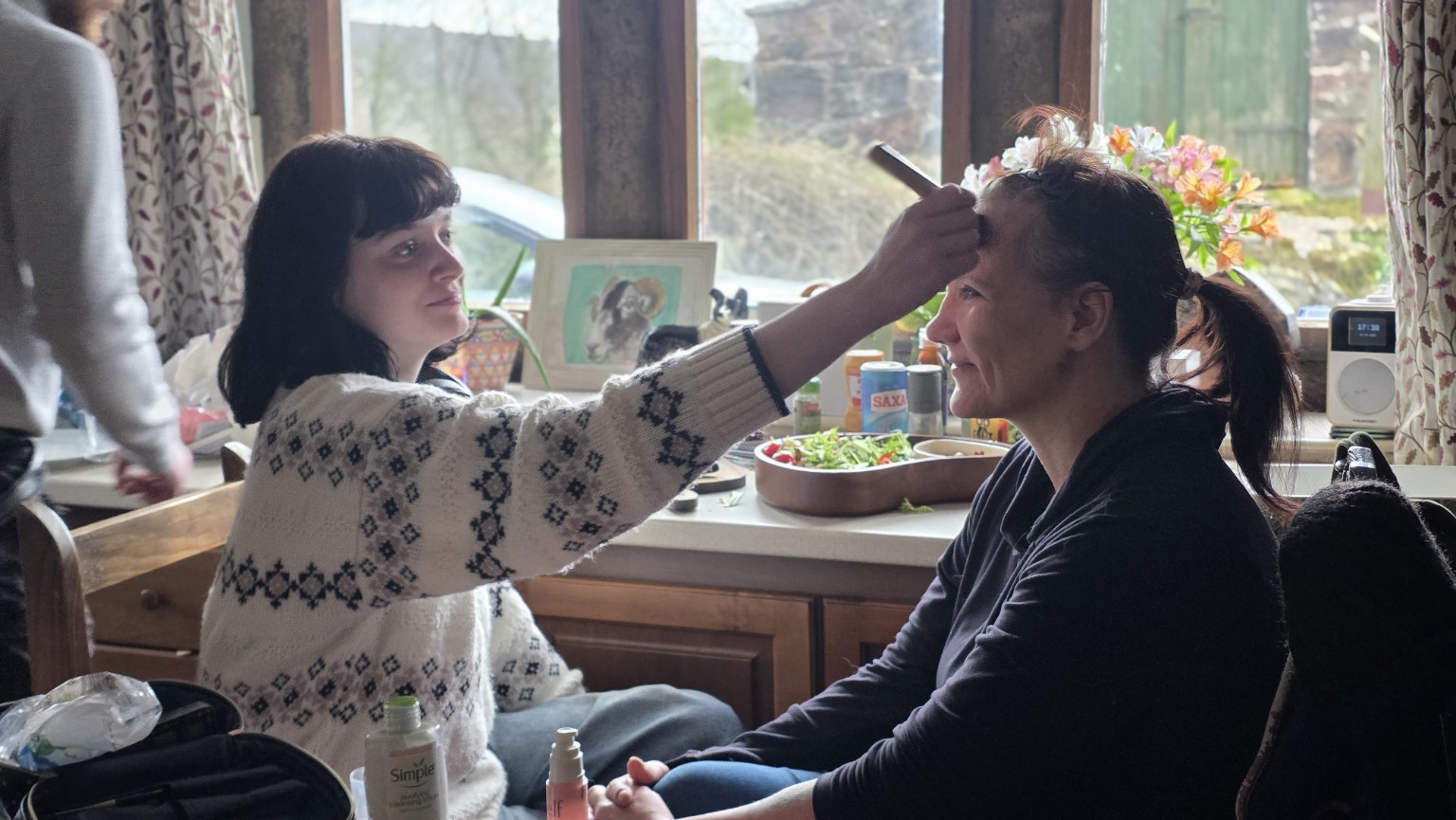 Tatum Hodgkinson-Rowe applying makeup on a film set
