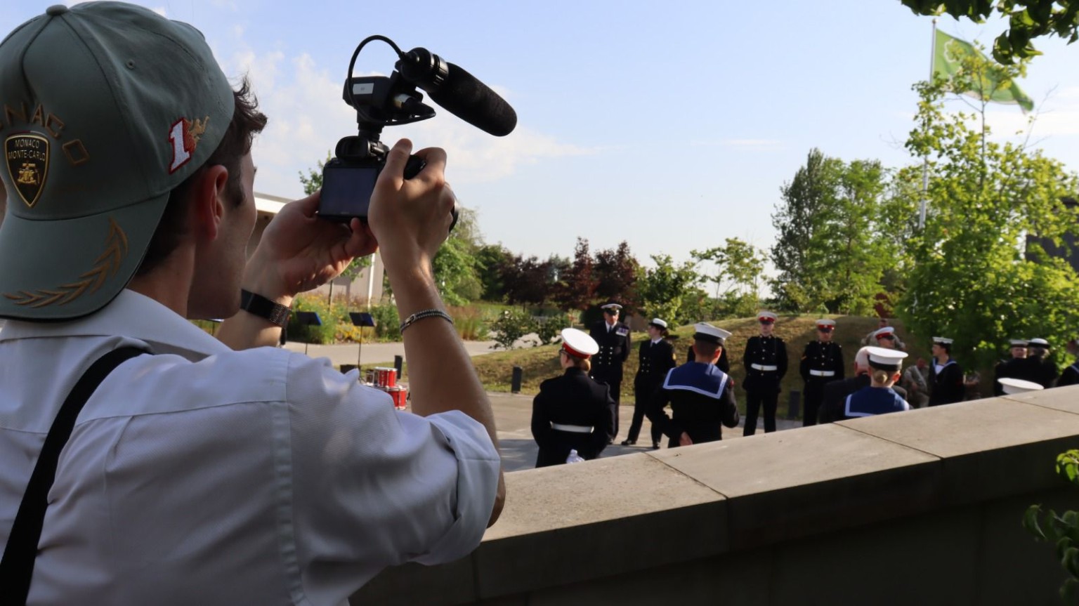 Camera operator filming uniformed participants