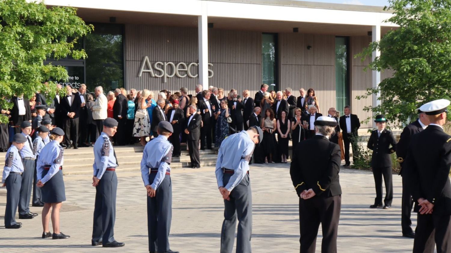 Guests and uniformed attendees gathered outside the venue